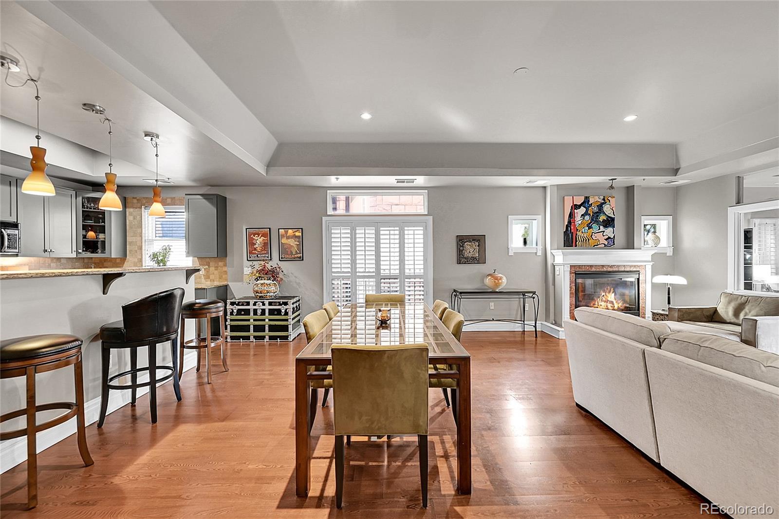 1352 Pennsylvania Street, Unit 2 Denver, CO 80203 - Photo 5 of 45 a living room with fireplace furniture and a wooden floor