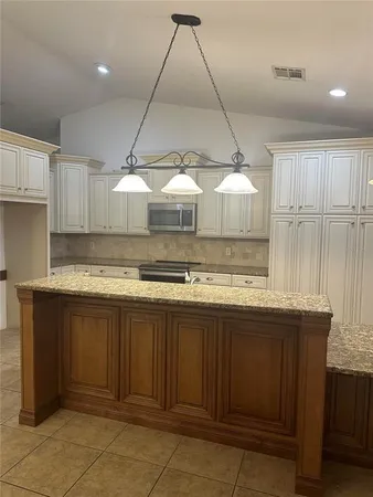 a kitchen with a sink and cabinets
