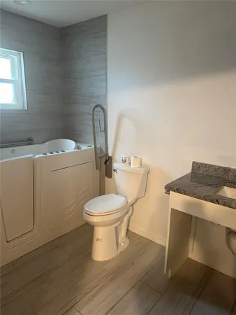 a white toilet sitting next to a bathroom sink