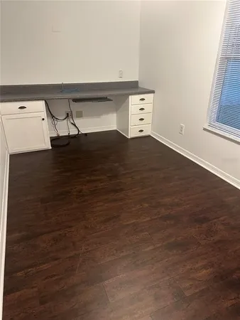 an empty room with wooden floor