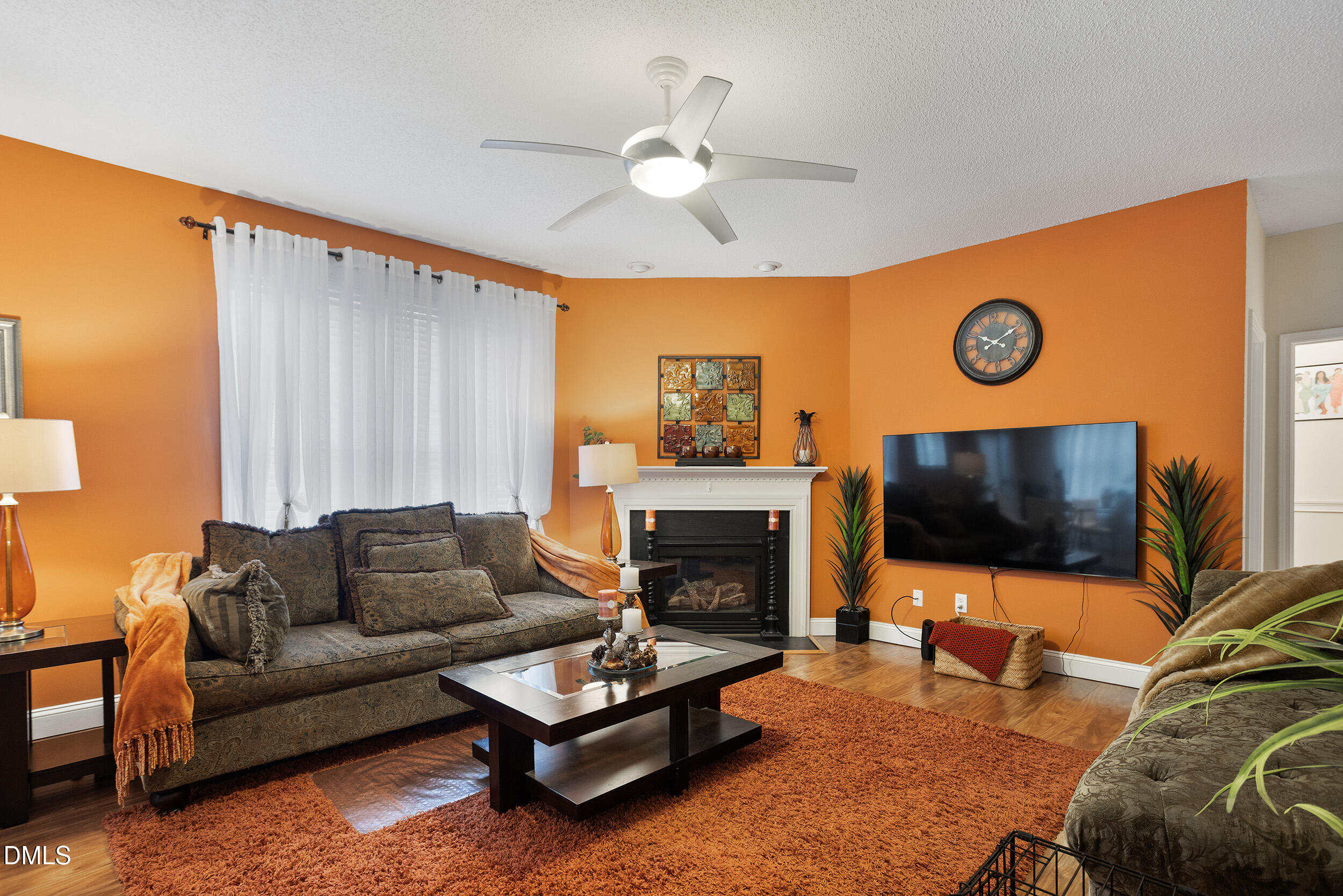 101 Cedar Key Landing Garner, NC 27529 - Photo 12 of 37 a living room with furniture a fireplace and a flat screen tv