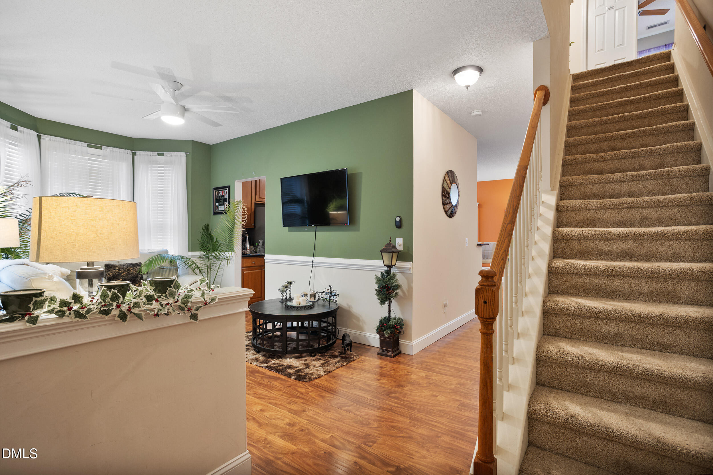 101 Cedar Key Landing Garner, NC 27529 - Photo 5 of 37 a view of living room kitchen with furniture and flat screen tv