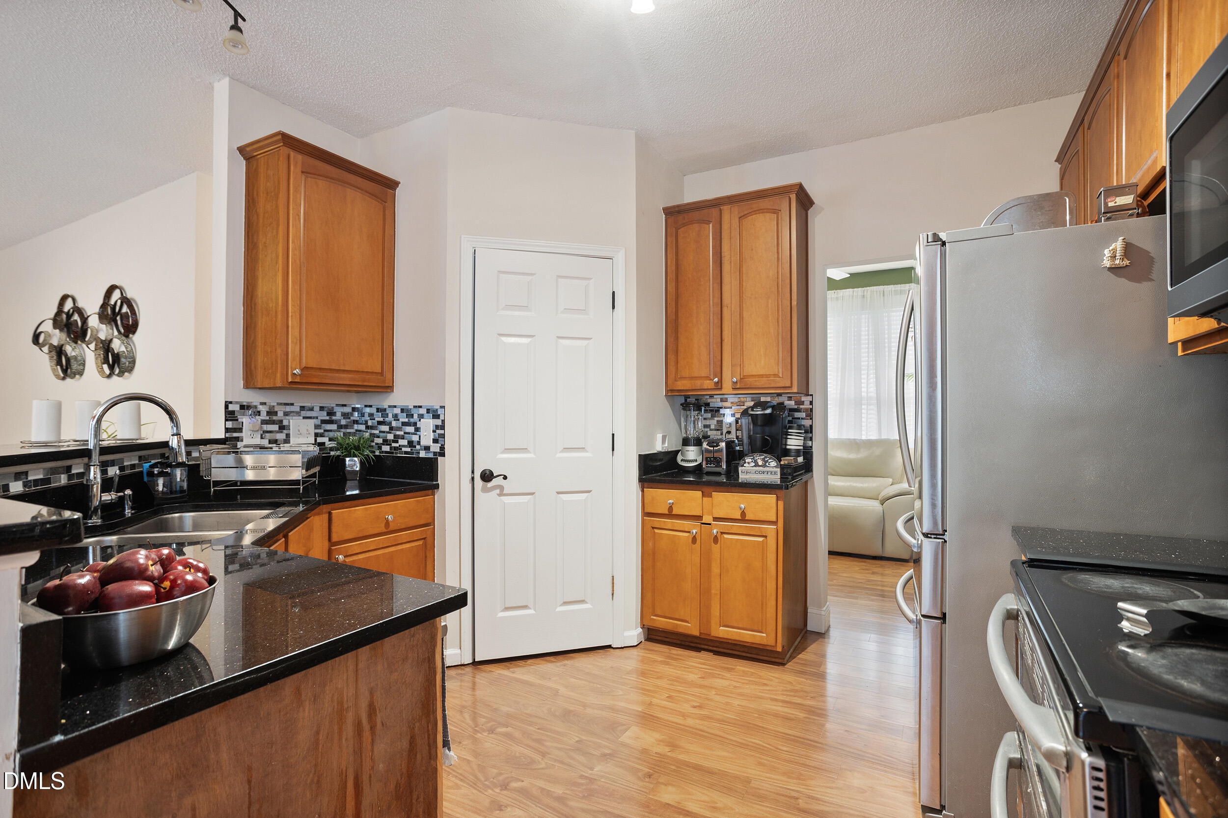 101 Cedar Key Landing Garner, NC 27529 - Photo 9 of 37 a kitchen with stainless steel appliances granite countertop a refrigerator and a stove top oven