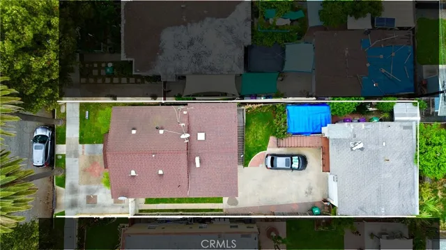 an aerial view of a house with a yard