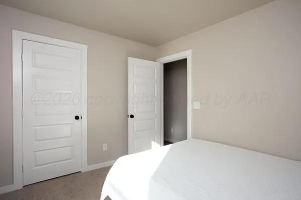 a bedroom with a bed and a cabinets