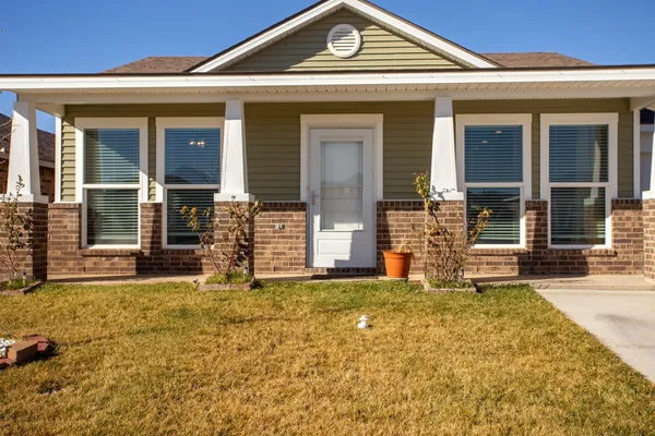 front view of a house with a large window