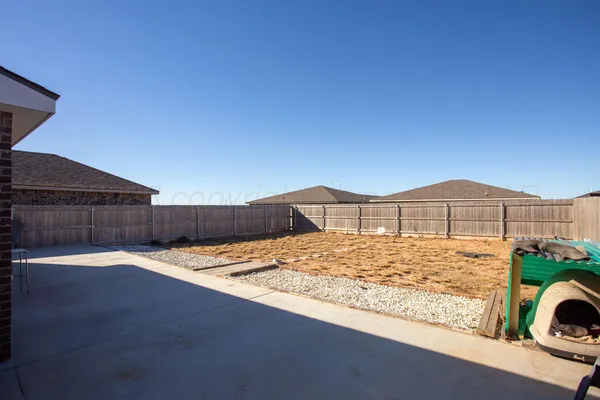 a view of a house with a wooden fence