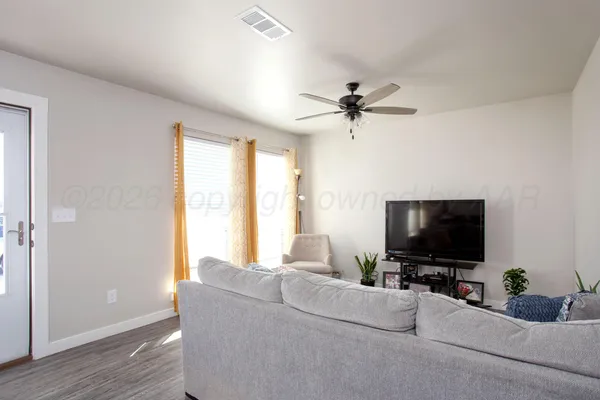a living room with furniture and a flat screen tv