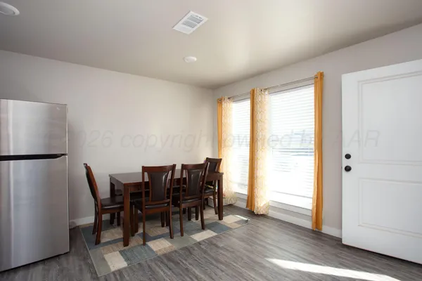 a view of a dining room with furniture and wooden floor