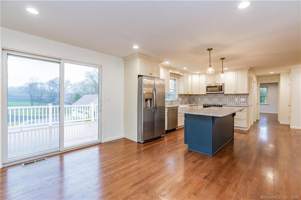 1241 Halladay Avenue West Suffield, CT 06078 - Photo 5 of 29 a view of kitchen with kitchen island wooden floor and refrigerator