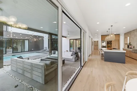 a spacious bathroom with a shower a mirror and a sink