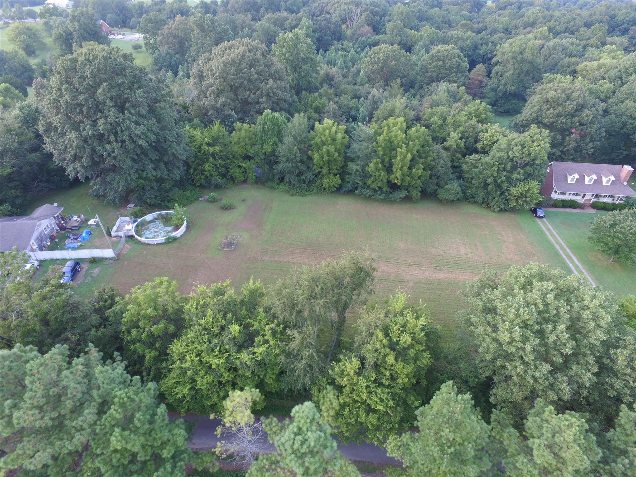 an aerial view of a house with yard and outdoor seating