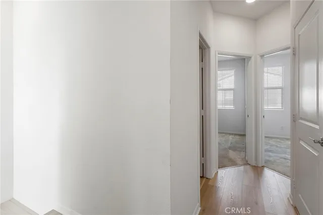 a view of hallway with wooden floor