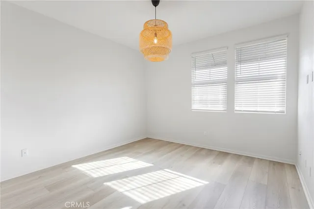 a view of a room with wooden floor and a ceiling fan