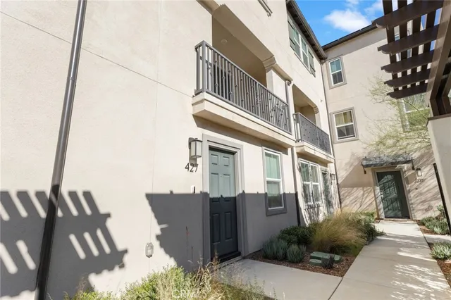 a kitchen with a sink a counter top space stainless steel appliances a window and a refrigerator