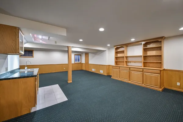 a kitchen with stainless steel appliances a refrigerator a sink and wooden cabinets