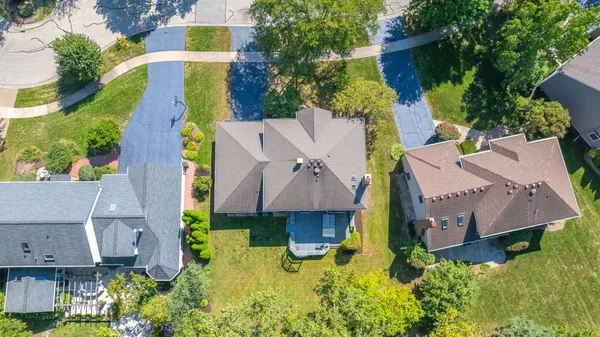 an aerial view of a house with swimming pool and garden space