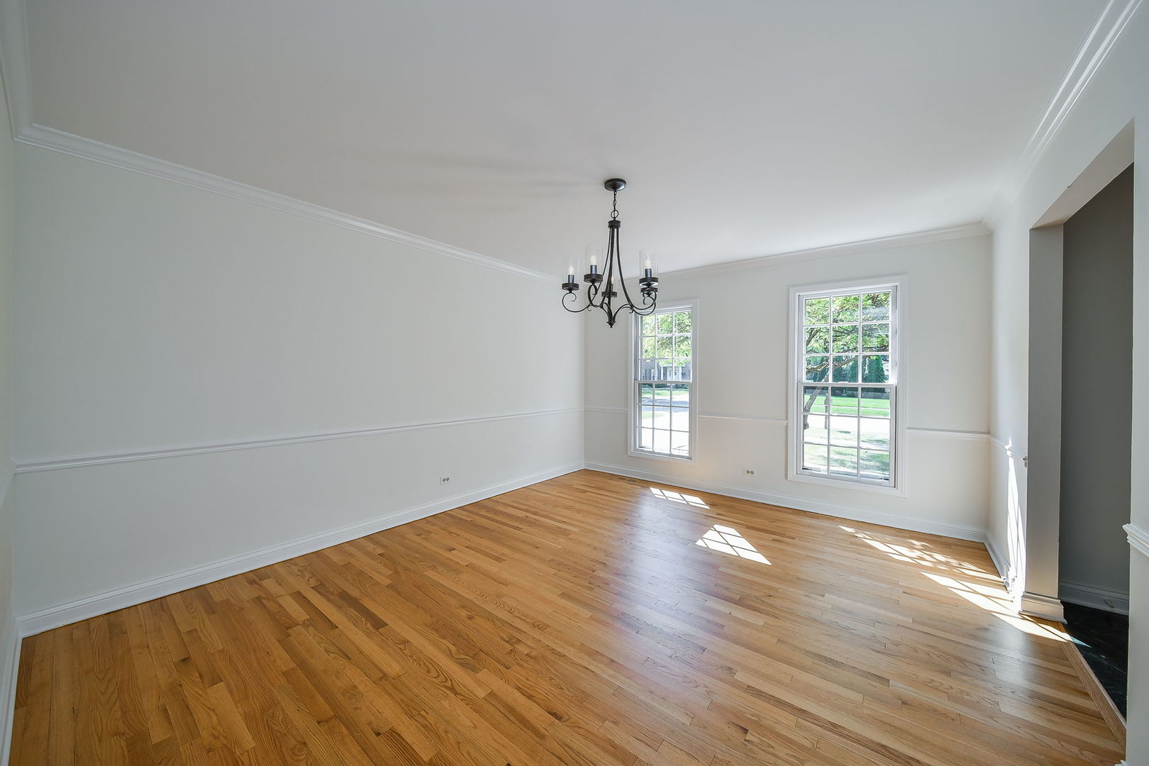 825 Biltmore Court Naperville, IL 60563 - Photo 6 of 43 wooden floor in an empty room with a window