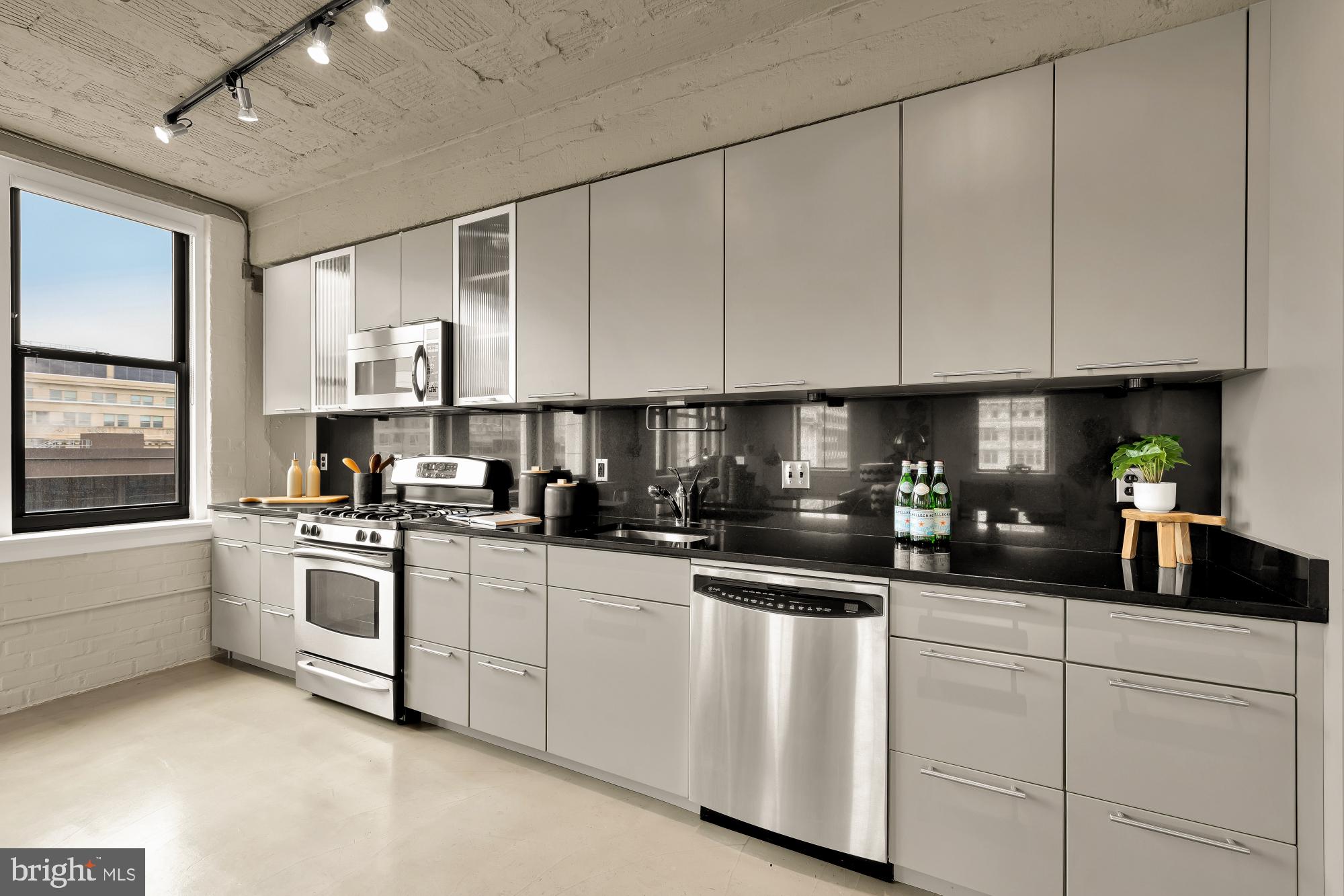 916 G St. Northwest, Unit 806 Washington, DC 20001 - Photo 8 of 19 a kitchen with white cabinets and white appliances