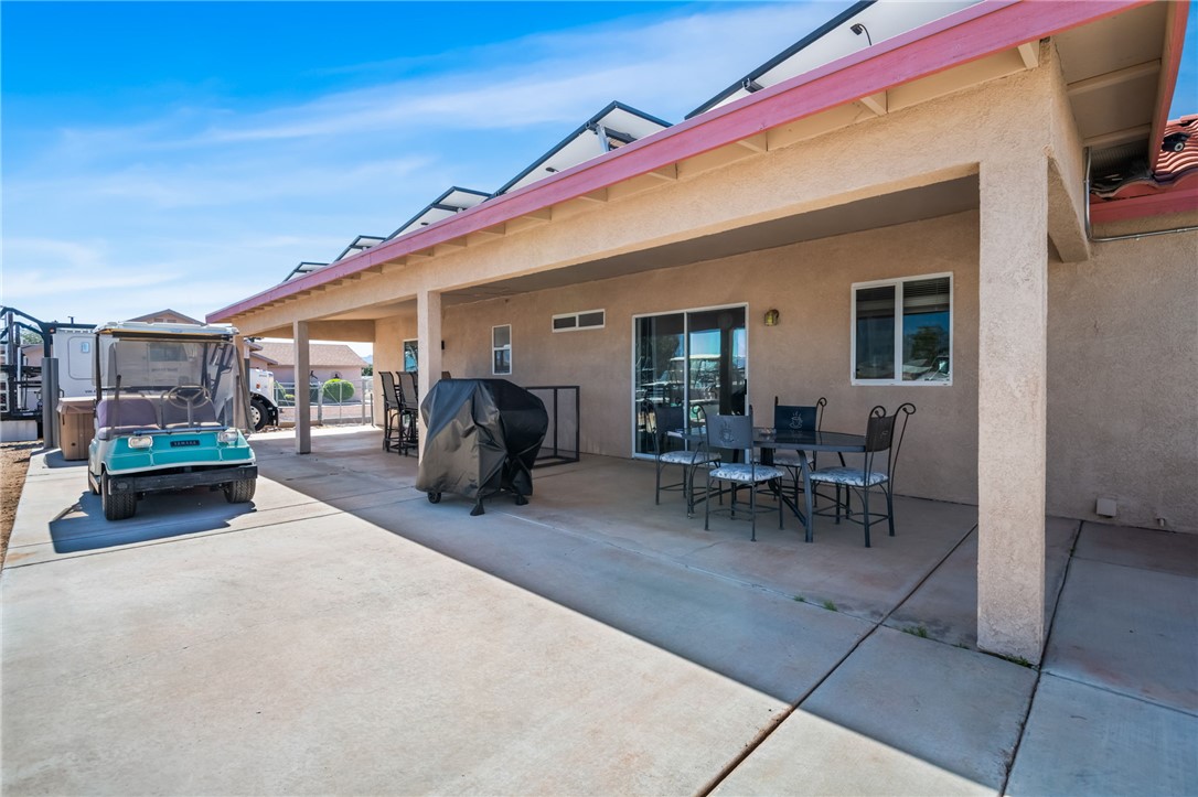 3668 North Neptune Road Golden Valley, AZ 86413 - Photo 11 of 38 The property features a concrete patio with a covered section, ideal for outdoor dining