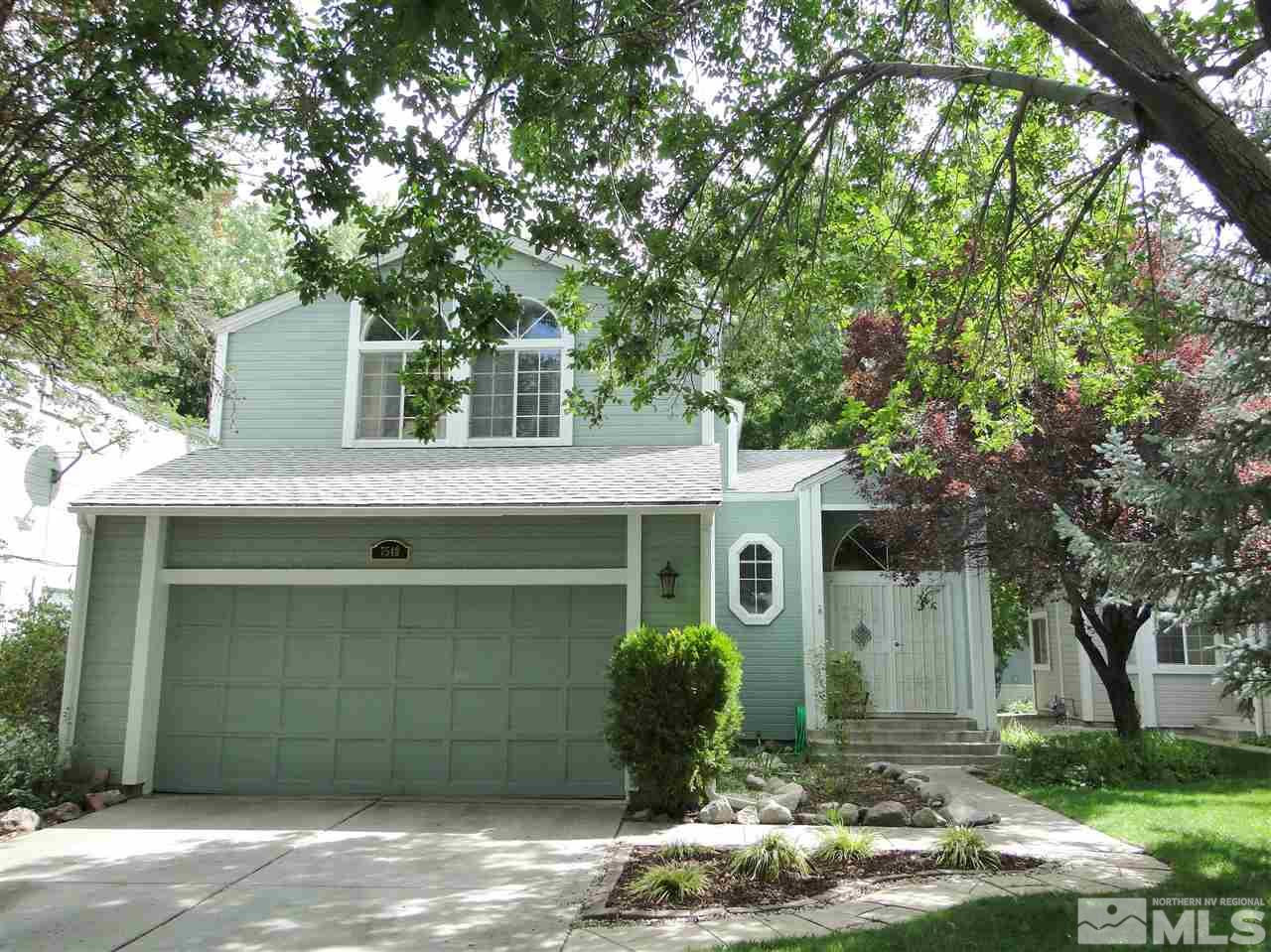 7540 Whimbleton Way Reno, NV 89511 - Photo 1 of 1 a front view of a house with a yard garage and outdoor seating