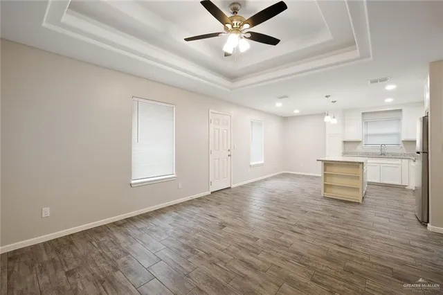 a view of an empty room kitchen and a window