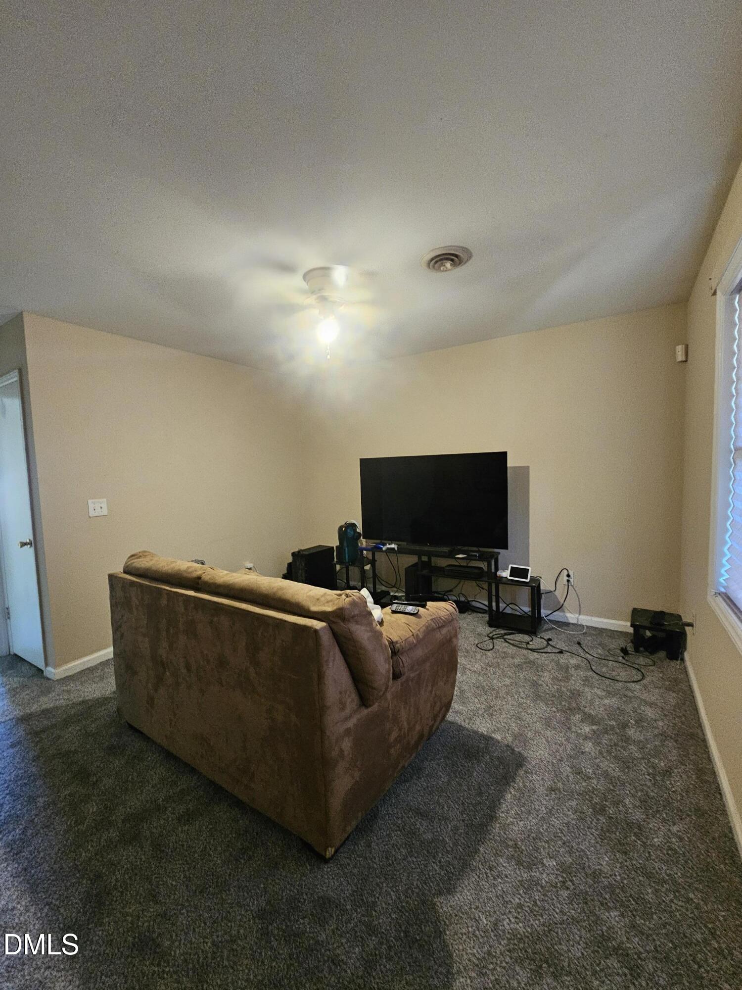 119 Lynn Drive Roxboro, NC 27573 - Photo 18 of 27 a living room with furniture and a flat screen tv
