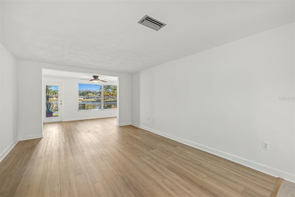 4324 Summersun Drive New Port Richey, FL 34652 - Photo 14 of 43 an empty room with wooden floor and windows
