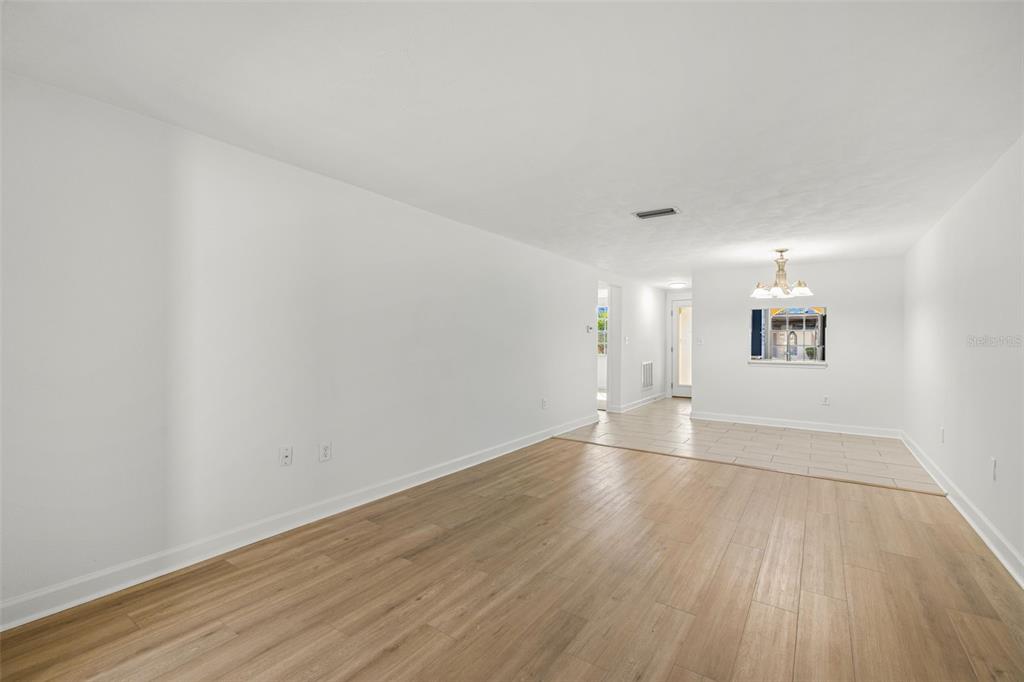4324 Summersun Drive New Port Richey, FL 34652 - Photo 15 of 43 an empty room with wooden floor and windows