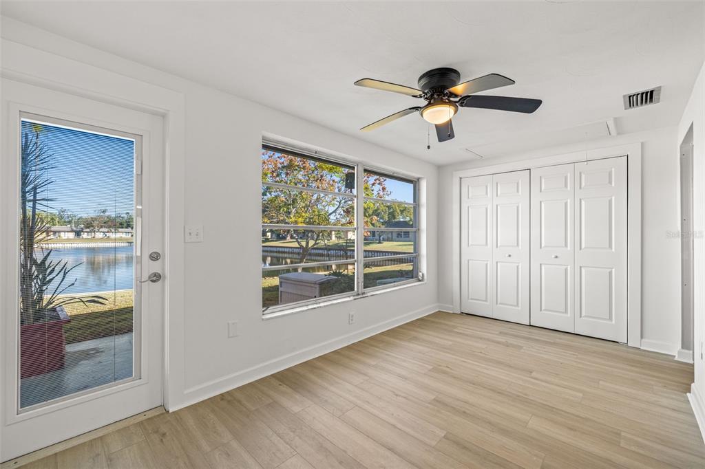 4324 Summersun Drive New Port Richey, FL 34652 - Photo 16 of 43 a view of empty room with wooden floor and fan