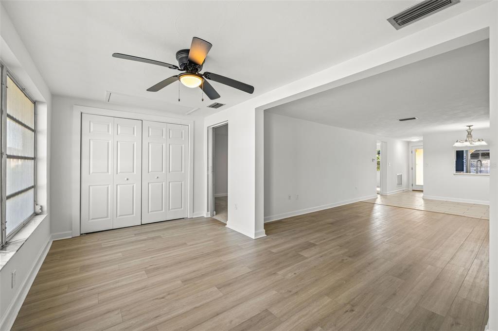 4324 Summersun Drive New Port Richey, FL 34652 - Photo 17 of 43 a view of empty room with wooden floor and fan