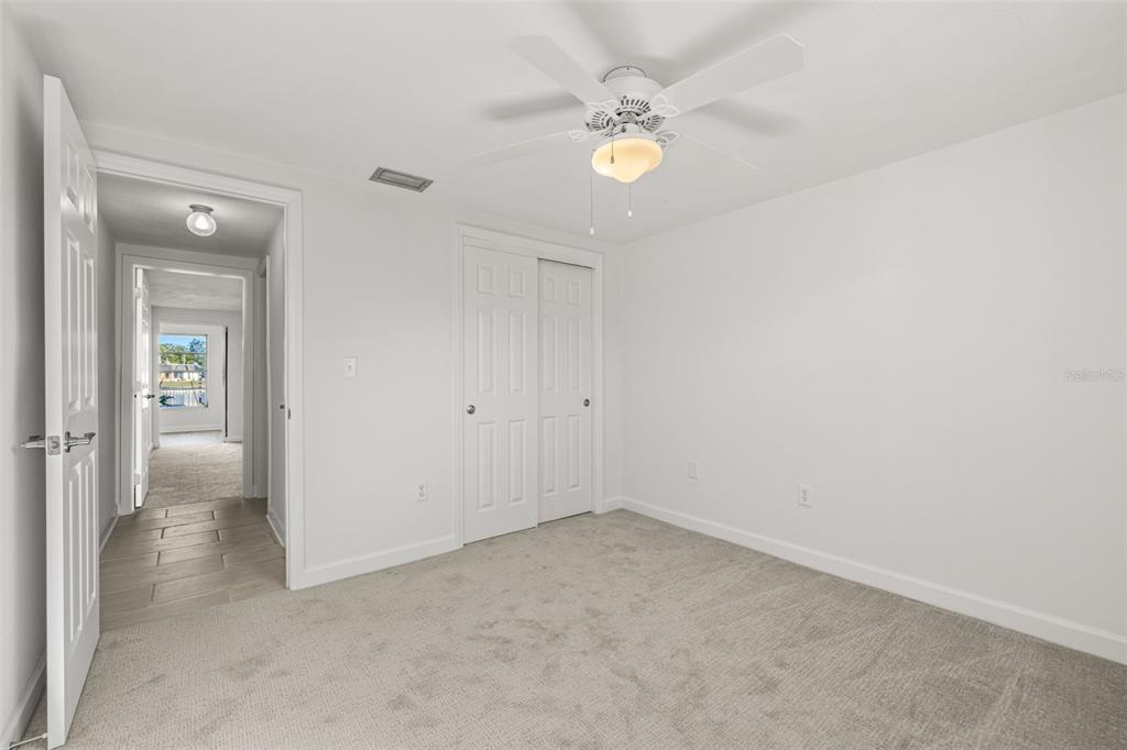4324 Summersun Drive New Port Richey, FL 34652 - Photo 25 of 43 an empty room with a chandelier fan and bathroom