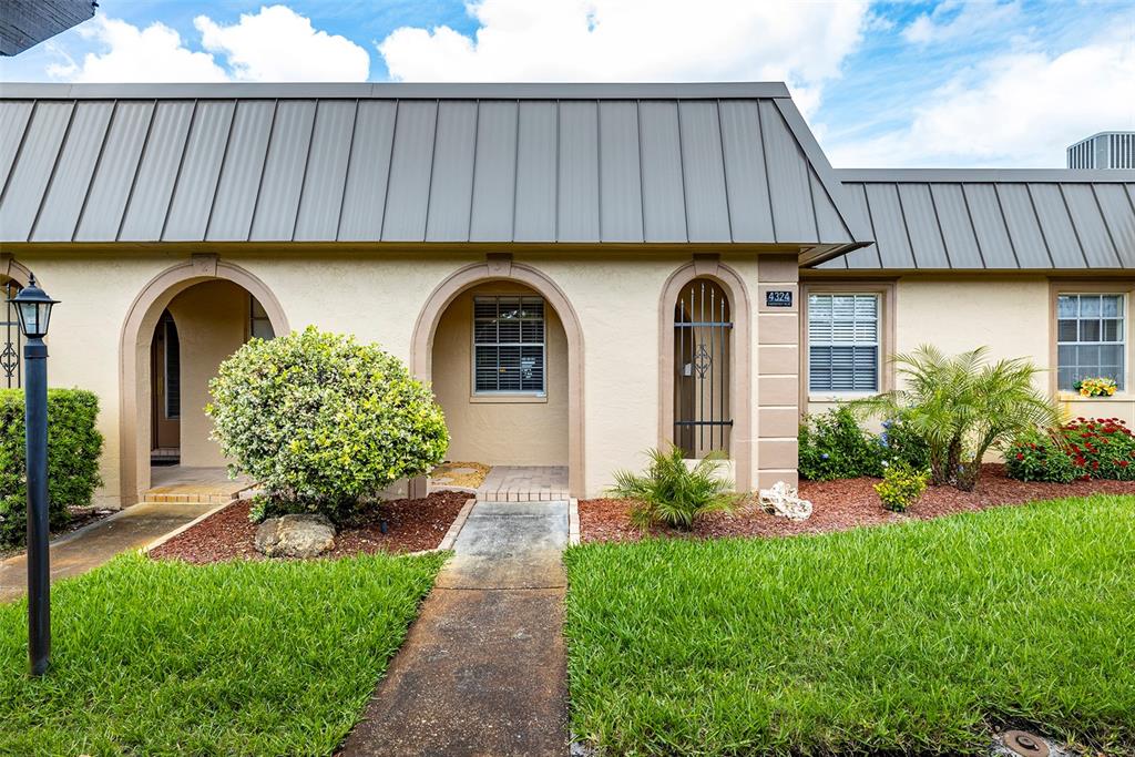 4324 Summersun Drive New Port Richey, FL 34652 - Photo 33 of 43 a front view of a house with garden
