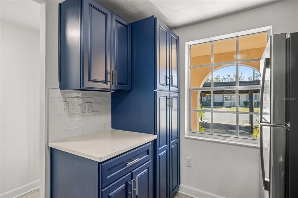4324 Summersun Drive New Port Richey, FL 34652 - Photo 10 of 43 a kitchen with a window a refrigerator and cabinets