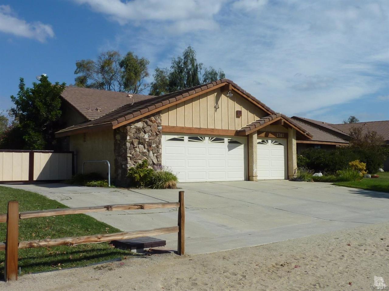 1707 Rambling Road Simi Valley, CA 93065 - Photo 2 of 29 a front view of a house with a yard and garage