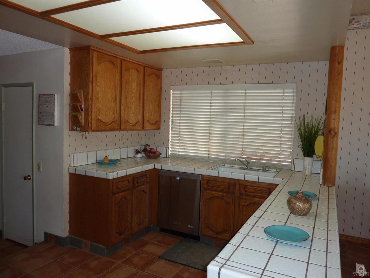 1707 Rambling Road Simi Valley, CA 93065 - Photo 11 of 29 a kitchen with a sink and cabinets