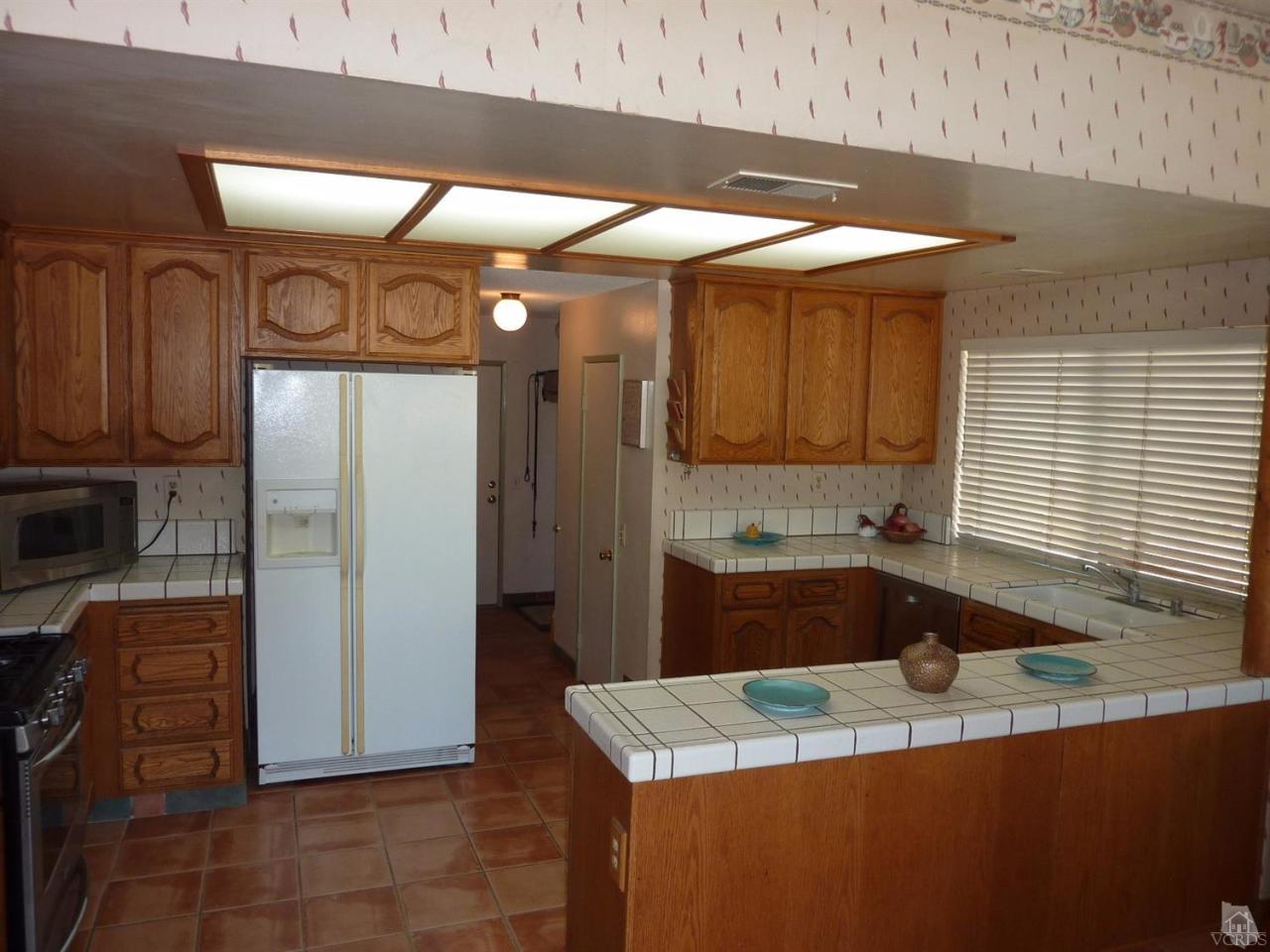 1707 Rambling Road Simi Valley, CA 93065 - Photo 12 of 29 a kitchen with stainless steel appliances granite countertop a sink a stove and a refrigerator