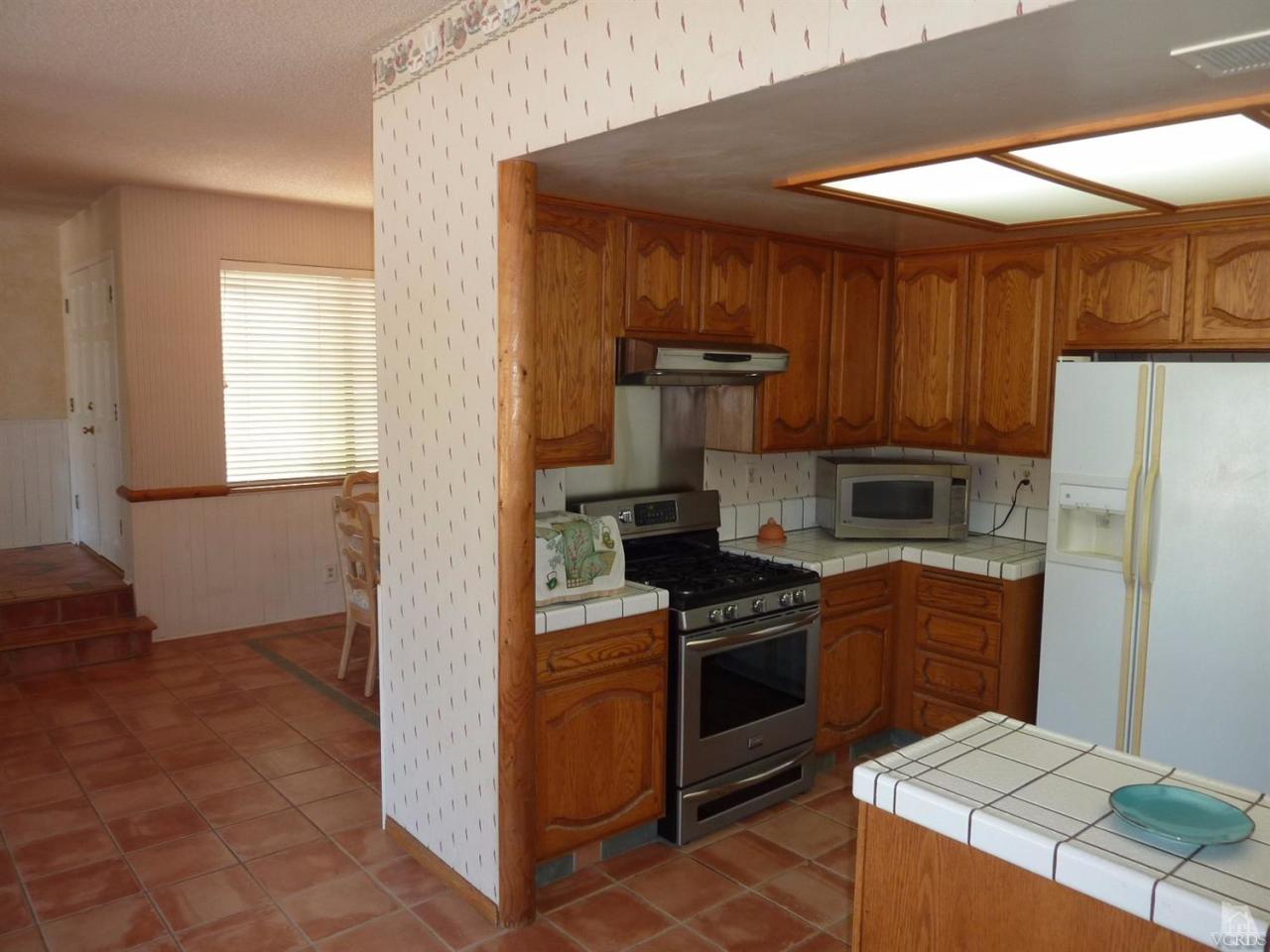 1707 Rambling Road Simi Valley, CA 93065 - Photo 13 of 29 a kitchen with a stove top oven and refrigerator
