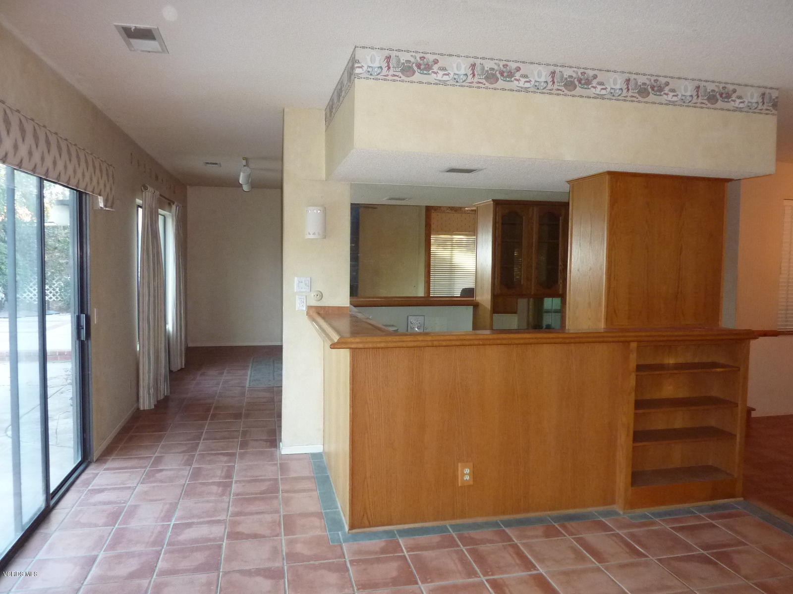 1707 Rambling Road Simi Valley, CA 93065 - Photo 16 of 29 a view of a hallway with wooden shelves