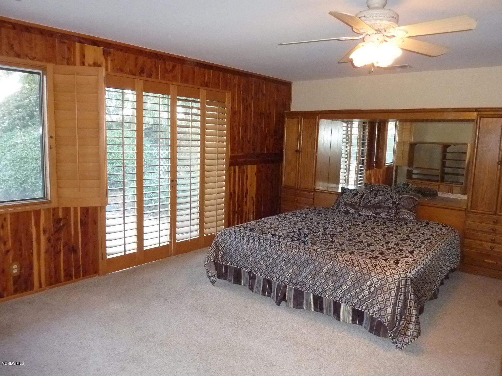 1707 Rambling Road Simi Valley, CA 93065 - Photo 19 of 29 a spacious bedroom with a large bed and a chandelier fan