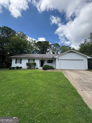 a front view of a house with a garden