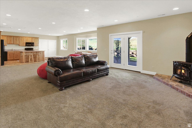 667 Hardscrabble Road Morgan, UT 84050 - Photo 40 of 51 Basement Family area with a wood stove, recessed lighting, and light colored carpet