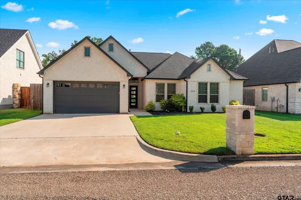 a front view of a house with a yard and garage