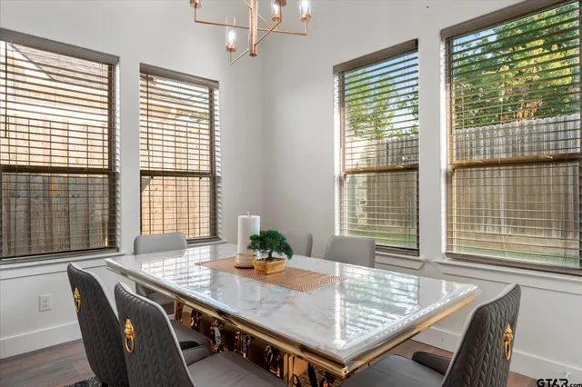 a view of a dining room with furniture and windows