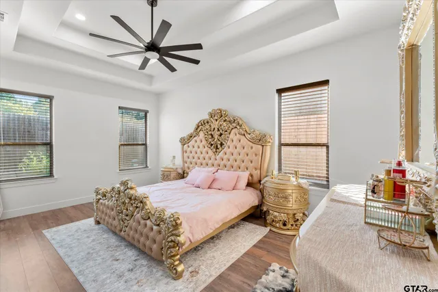 a bedroom with a large bed and a chandelier