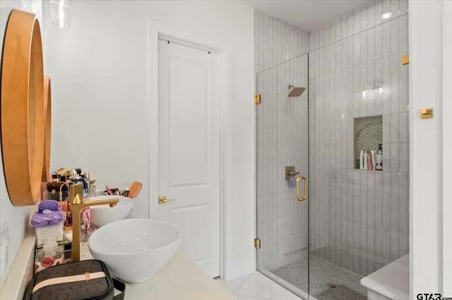 a bathroom with a sink and mirror with toilet