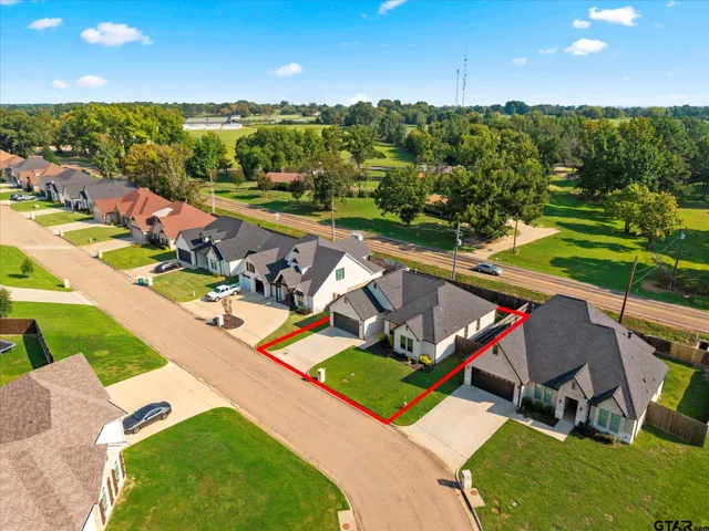an aerial view of a house with a garden and swimming pool