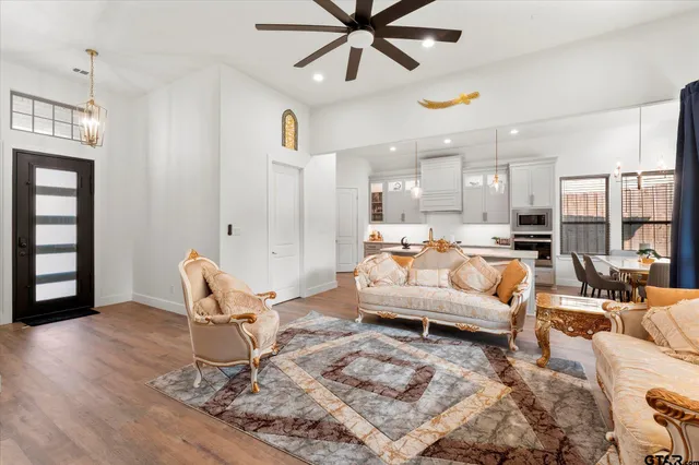 a living room with furniture and kitchen view