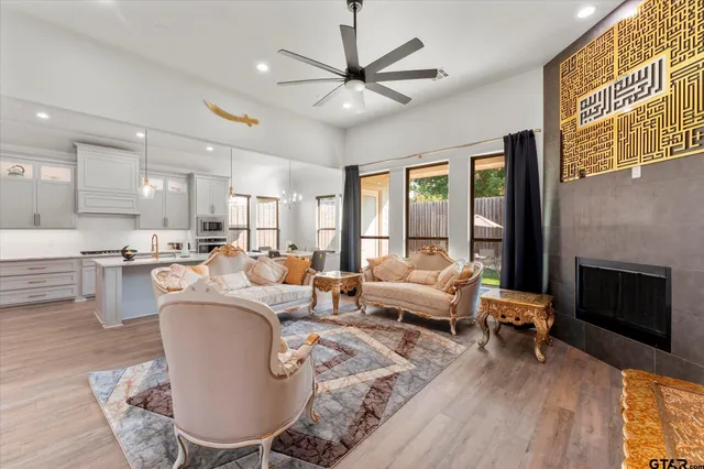 a living room with fireplace furniture and a large window