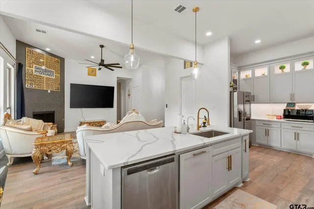 a kitchen that has a sink and a stove in it